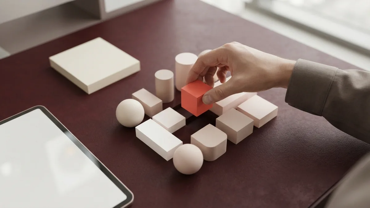 Hand selecting a coral shape among abstract business forms for niche choice