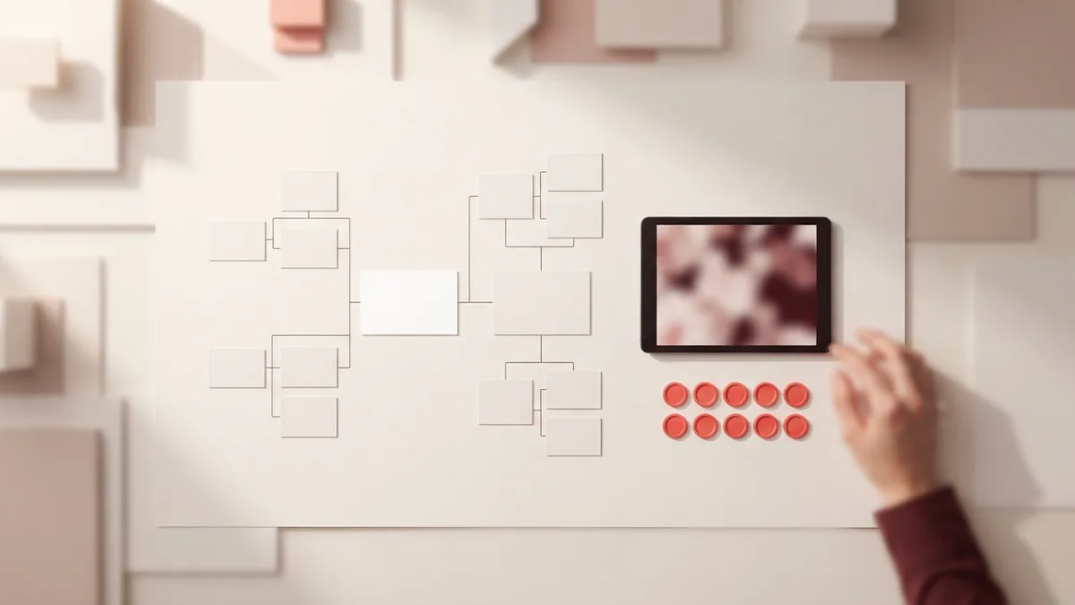 Blank payout cards arranged in a branching pattern beside a tablet and coral tokens